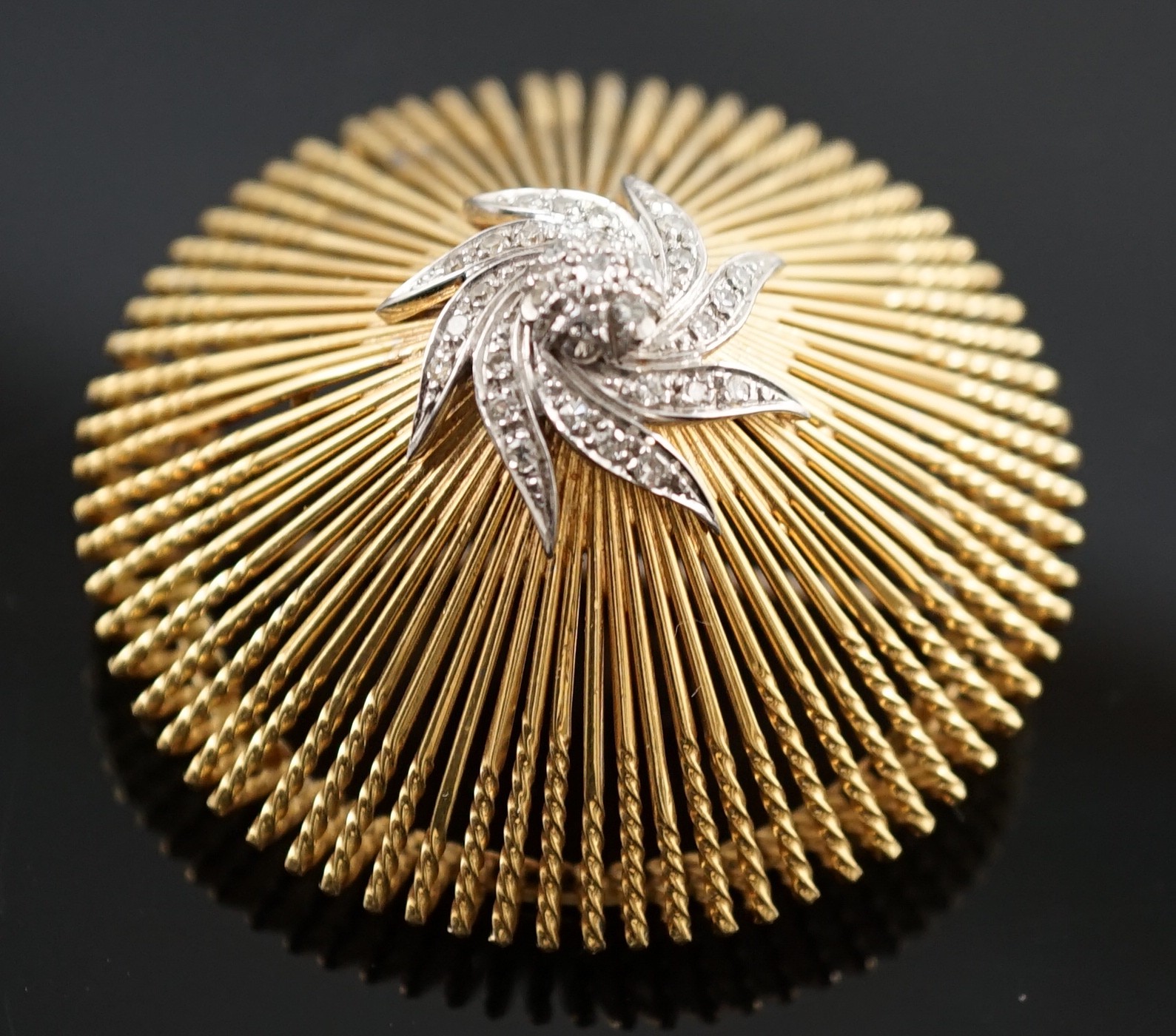A modern stylish Italian pierced 18k and diamond chip set domed brooch